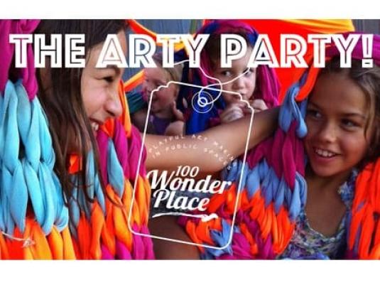poster for arty party with children smiling in colourful blankets