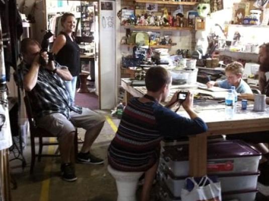 people around a table making artwork and taking photos