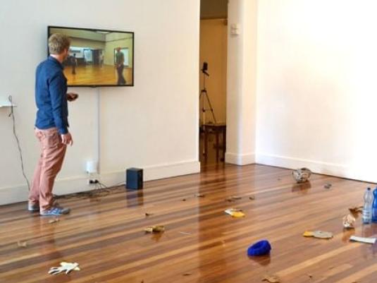 Man standing  in room watching scene