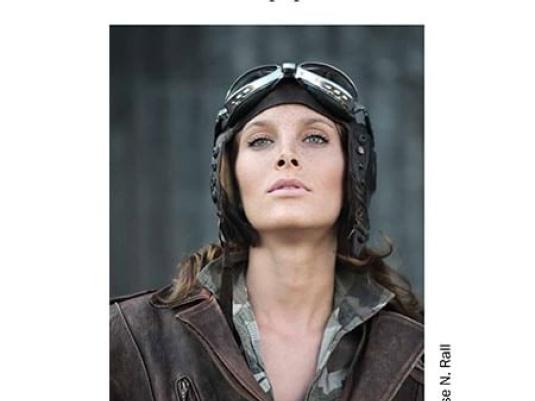 book cover with woman wearing brown leather bomber jacket and aviator goggles on top of her head